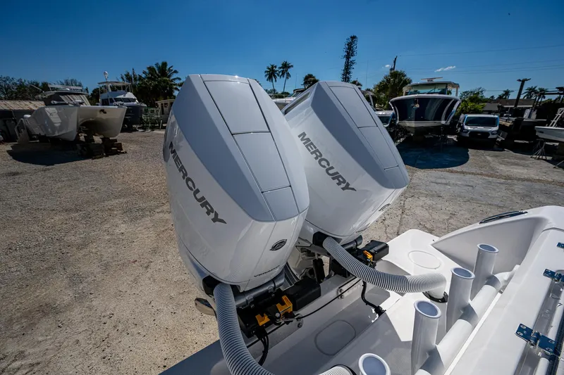  Yacht Photos Pics 2025 Invincible 33 Open Fisherman with dual Mercury outboard engines in a sunny marina.