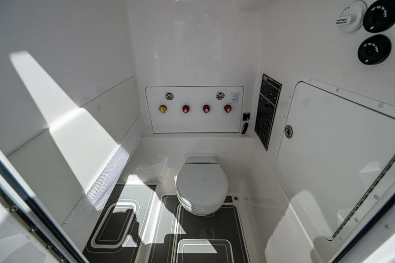  Yacht Photos Pics 2025 Invincible 33 Open Fisherman boat interior with modern marine toilet and control panel.