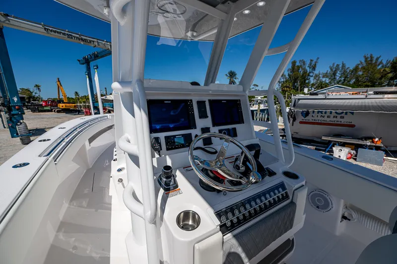  Yacht Photos Pics 2025 Invincible 33 Open Fisherman boat cockpit with modern controls and steering wheel.