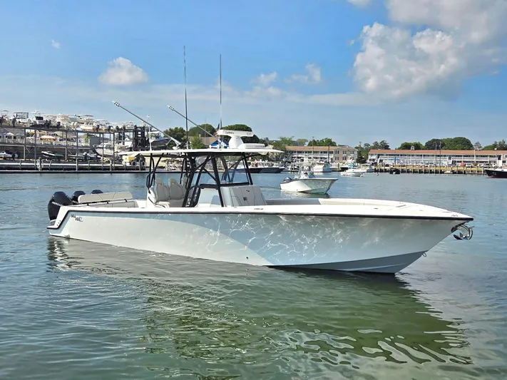  Yacht Photos Pics 2023 SeaVee 37 Z boat on calm water, clear sky, marina background.