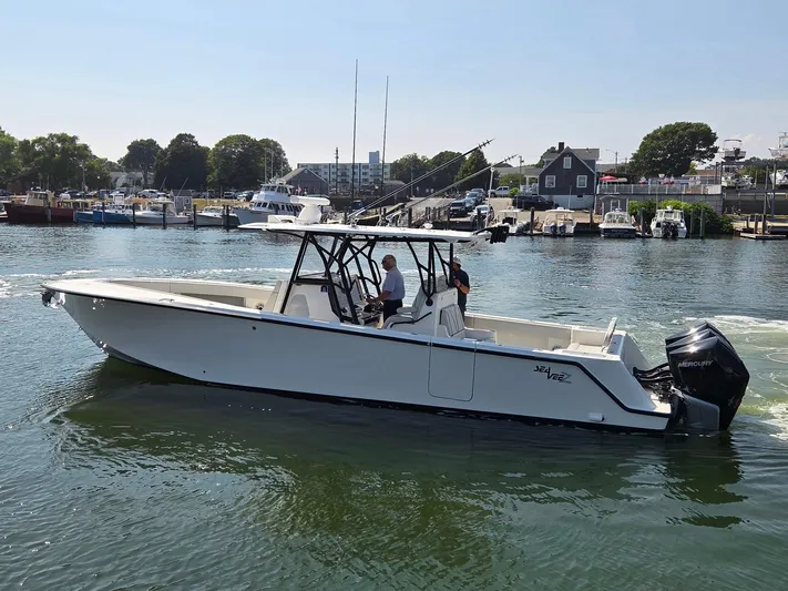  Yacht Photos Pics 2023 SeaVee 37 Z boat cruising in a marina with outboard engines.