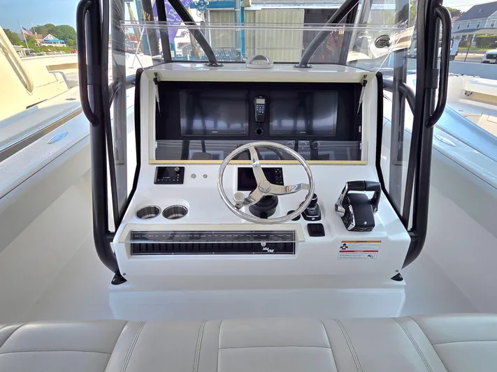  Yacht Photos Pics 2023 SeaVee 37 Z boat helm with steering wheel and control panel.