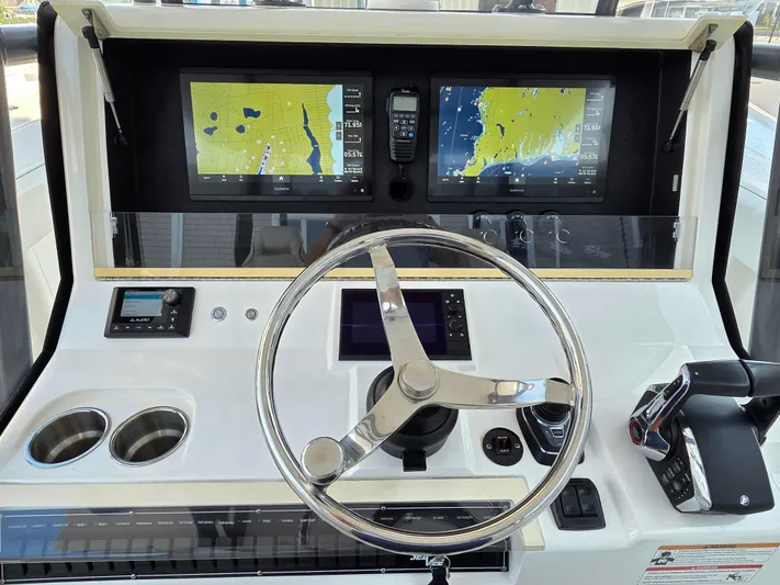  Yacht Photos Pics 2023 SeaVee 37 Z boat dashboard with dual navigation screens and steering wheel.