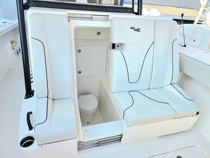  Yacht Photos Pics 2023 SeaVee 37 Z boat interior with white seating and built-in toilet.
