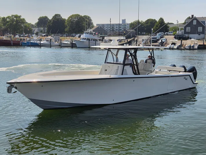  Yacht Photos Pics 2023 SeaVee 37 Z boat docked in a marina, surrounded by other vessels.