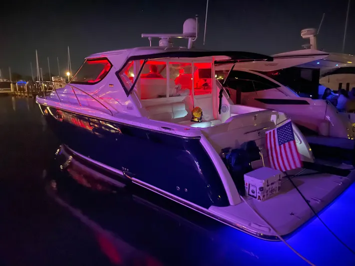  Yacht Photos Pics 2009 Tiara Yachts 4300 Sovran at night, illuminated with red and blue lights.