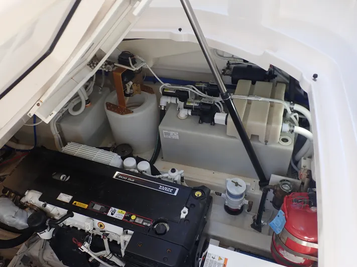 Yacht Photos Pics Engine compartment of 2009 Tiara Yachts 4300 Sovran, showcasing mechanical components and fire extinguisher.