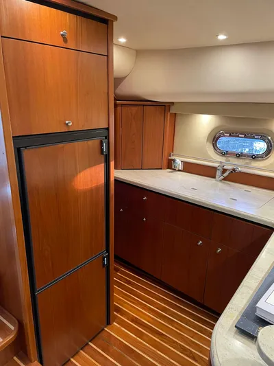  Yacht Photos Pics 2009 Tiara Yachts 4300 Sovran interior kitchen with wood cabinetry and modern appliances.