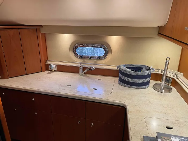  Yacht Photos Pics 2009 Tiara Yachts 4300 Sovran interior kitchen with wooden cabinets and modern fixtures.