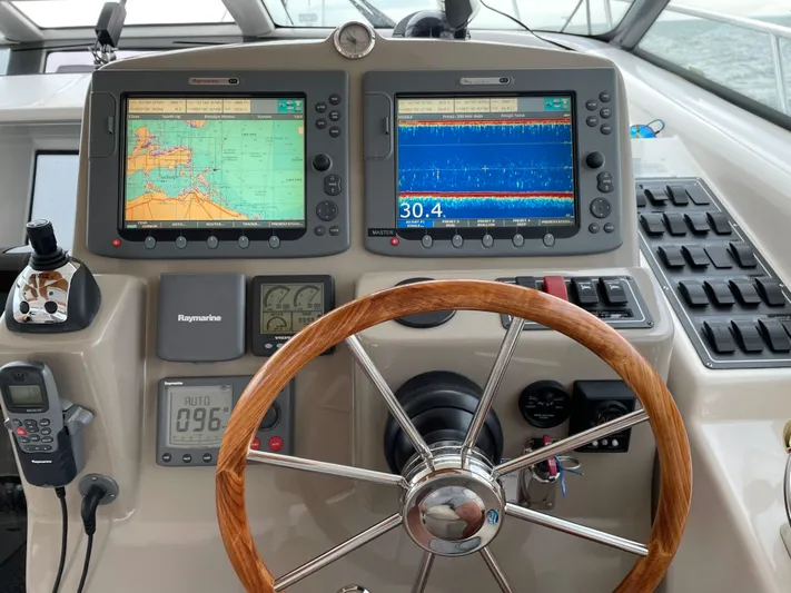  Yacht Photos Pics Helm of 2009 Tiara Yachts 4300 Sovran with navigation displays and wooden steering wheel.