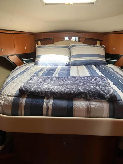  Yacht Photos Pics Luxurious cabin interior of 2009 Tiara Yachts 4300 Sovran with striped bedding.