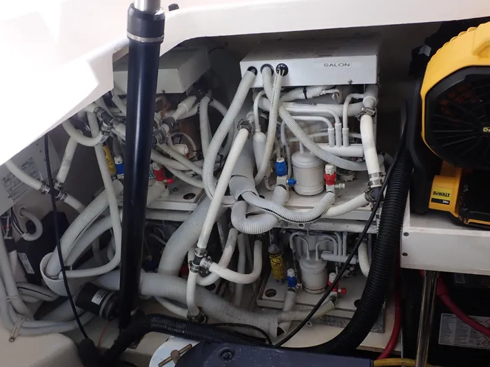  Yacht Photos Pics Engine compartment of a 2009 Tiara Yachts 4300 Sovran, showcasing complex piping and machinery.
