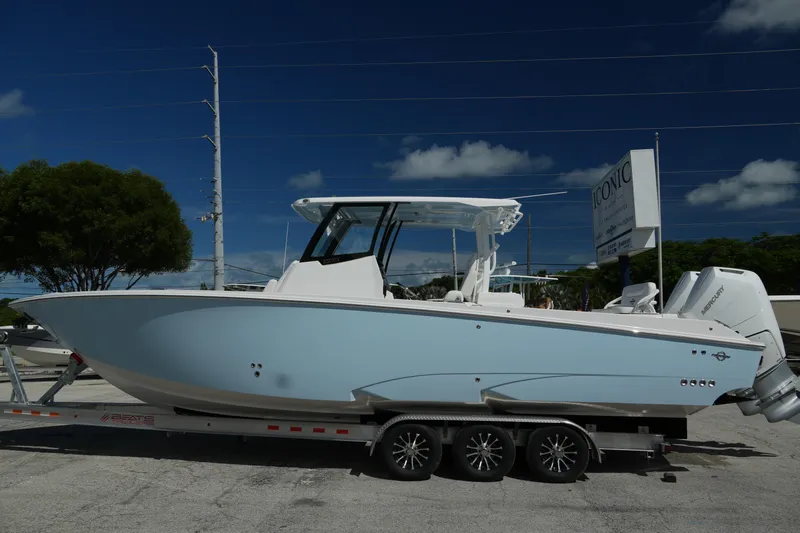 Yacht Photos Pics 2025 Fountain 32 NX boat on trailer, side view under clear blue sky.