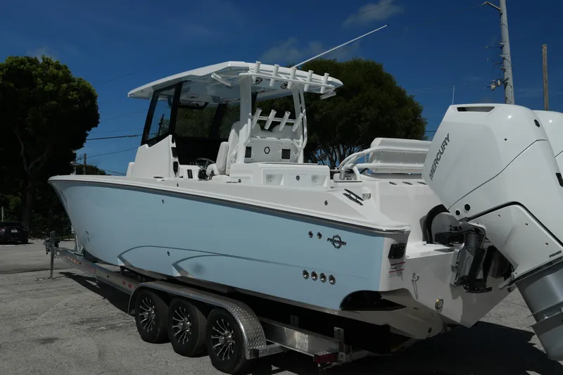  Yacht Photos Pics 2025 Fountain 32 NX boat on trailer, featuring sleek design and powerful Mercury engines.