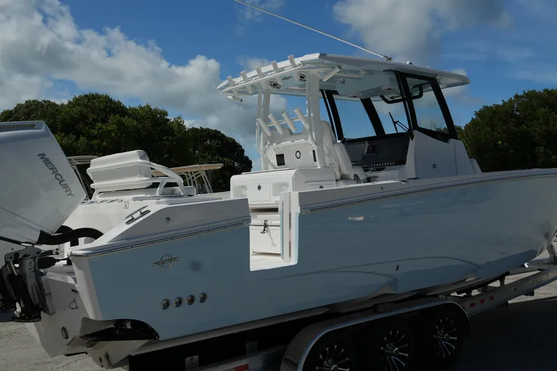  Yacht Photos Pics 2025 Fountain 32 NX boat on trailer, featuring sleek design and Mercury engine.