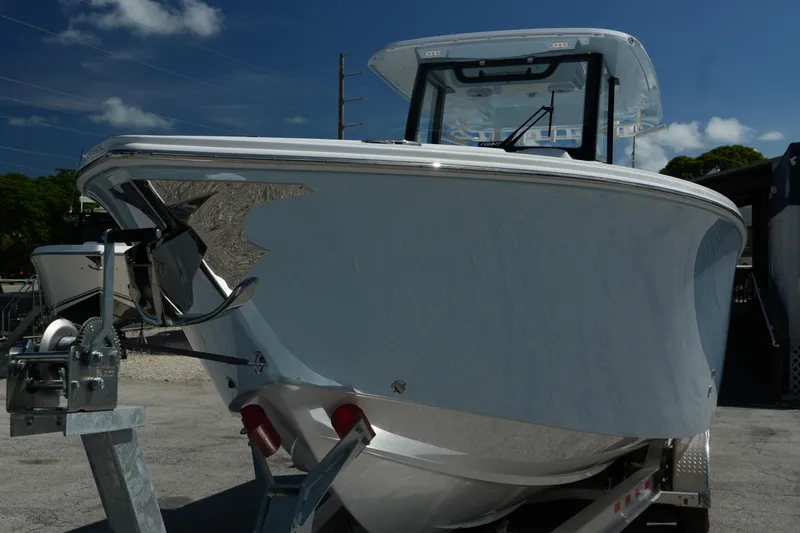  Yacht Photos Pics 2025 Fountain 32 NX boat on trailer under clear blue sky.