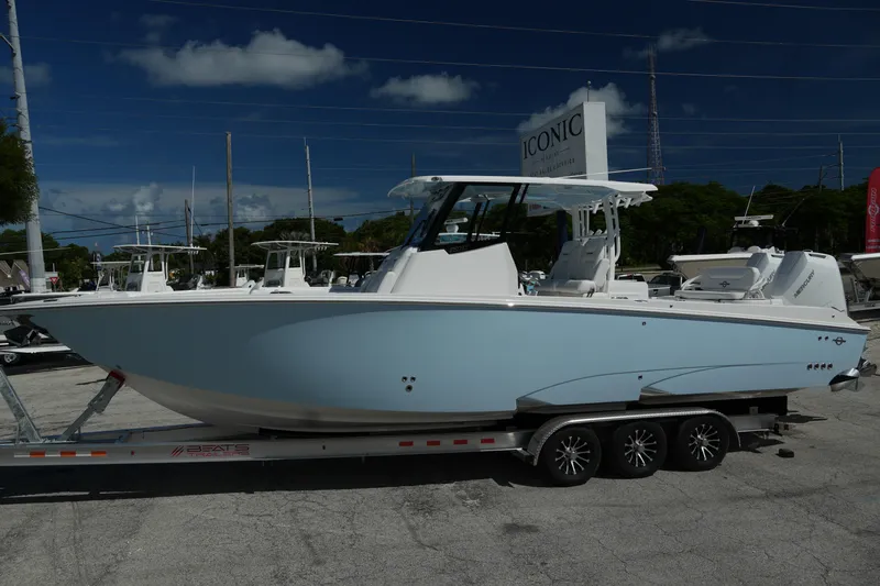  Yacht Photos Pics 2025 Fountain 32 NX boat on trailer, displayed outdoors under clear sky.