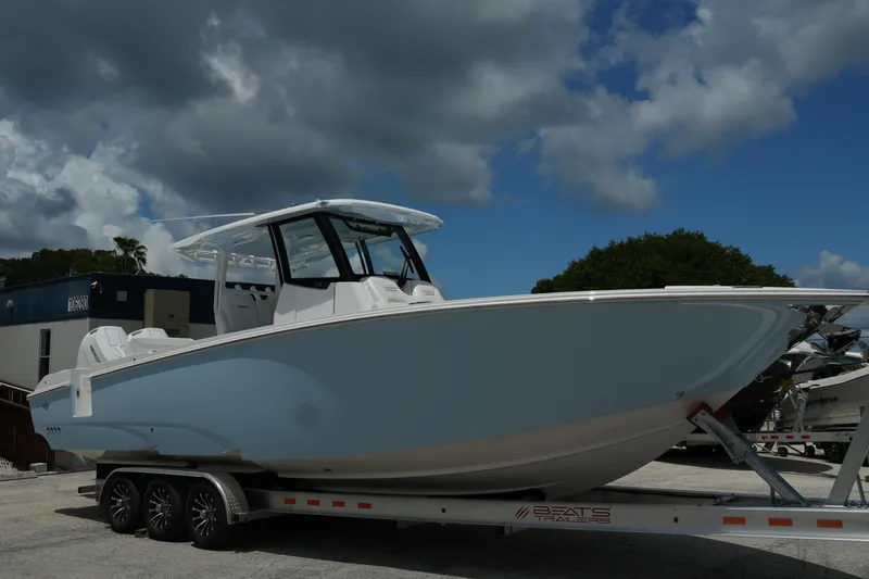  Yacht Photos Pics 2025 Fountain 32 NX boat on trailer under cloudy sky.