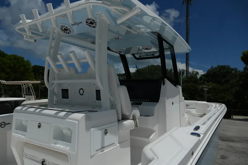  Yacht Photos Pics 2025 Fountain 32 NX boat with sleek design and advanced features, docked under a clear blue sky.