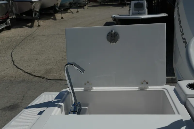  Yacht Photos Pics Open storage compartment on a 2025 Fountain 32 NX boat, featuring a sleek faucet design.