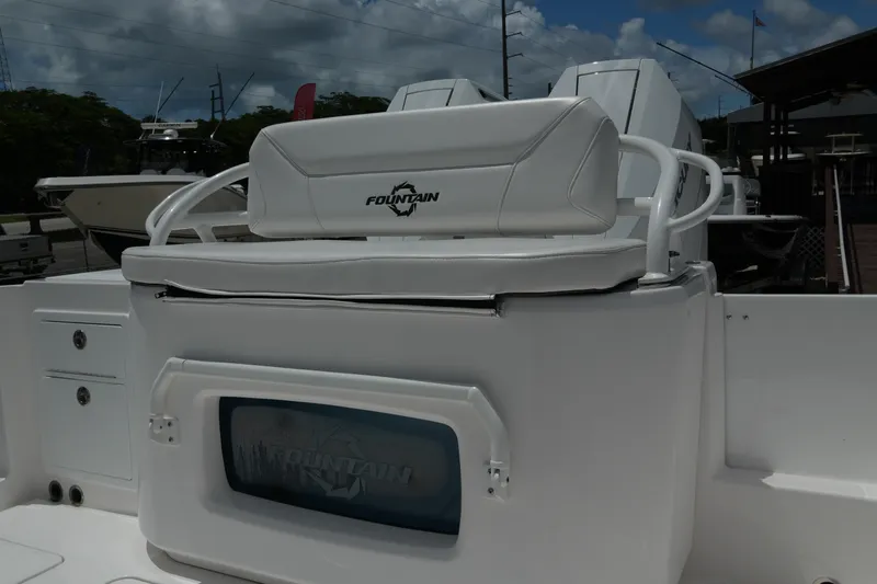  Yacht Photos Pics 2025 Fountain 32 NX boat interior with white seating and storage compartment.