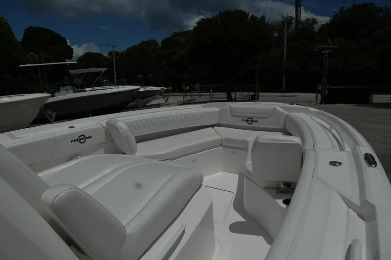  Yacht Photos Pics 2025 Fountain 32 NX boat with luxurious white seating and sleek design.