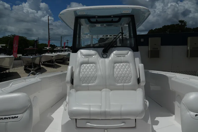  Yacht Photos Pics 2025 Fountain 32 NX boat interior with luxurious white seating and modern design.