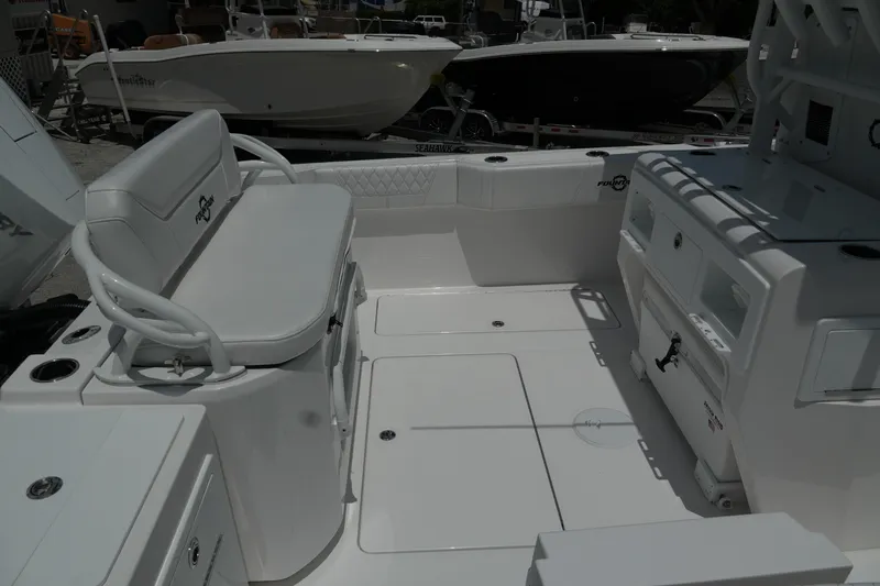  Yacht Photos Pics 2025 Fountain 32 NX boat interior with seating and storage compartments.