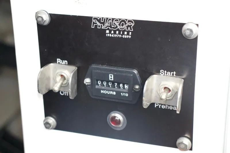  Yacht Photos Pics Control panel of a 2002 McKinna 57 Pilothouse with hour meter and switches.