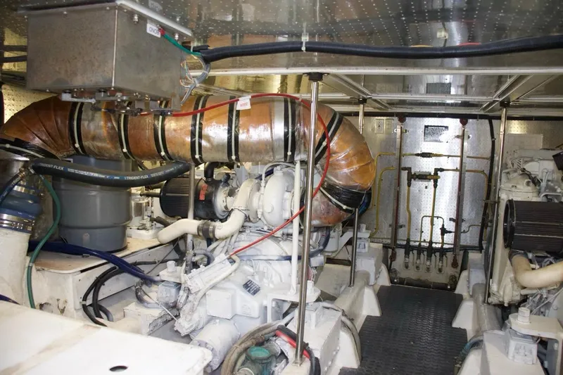  Yacht Photos Pics Engine room of 2002 McKinna 57 Pilothouse yacht, showcasing mechanical components and piping.