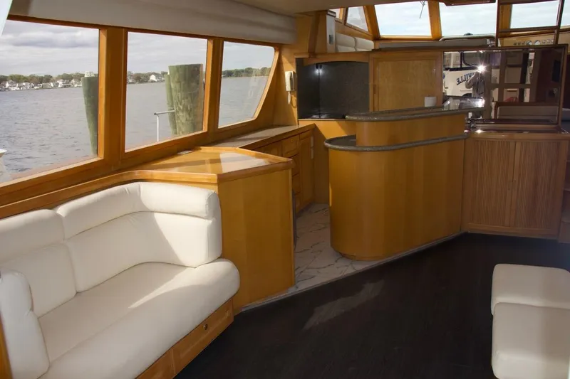  Yacht Photos Pics Luxurious interior of 2002 McKinna 57 Pilothouse yacht with elegant wood and leather furnishings.