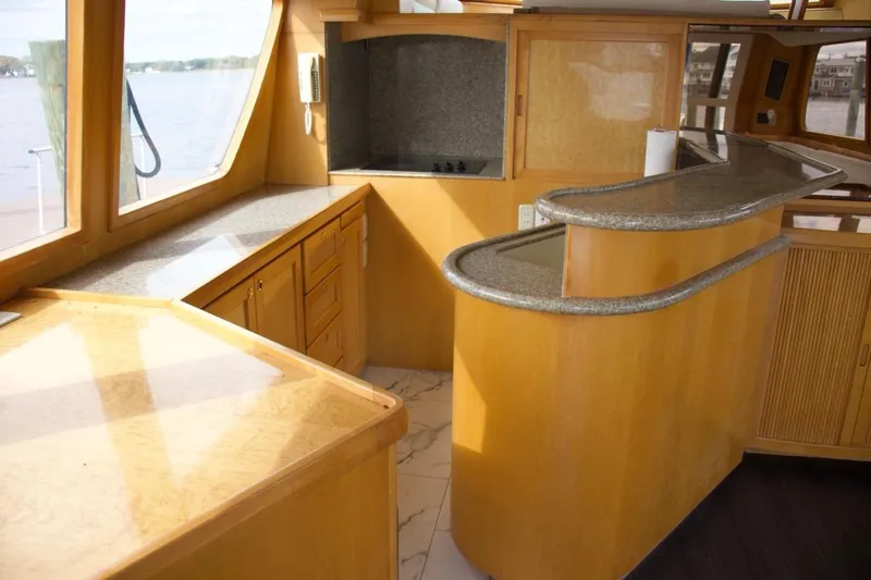  Yacht Photos Pics Luxurious 2002 McKinna 57 Pilothouse interior with elegant wood and granite finishes.