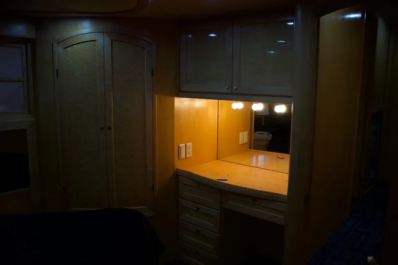 Yacht Photos Pics Interior of 2002 McKinna 57 Pilothouse with illuminated vanity and wooden cabinetry.