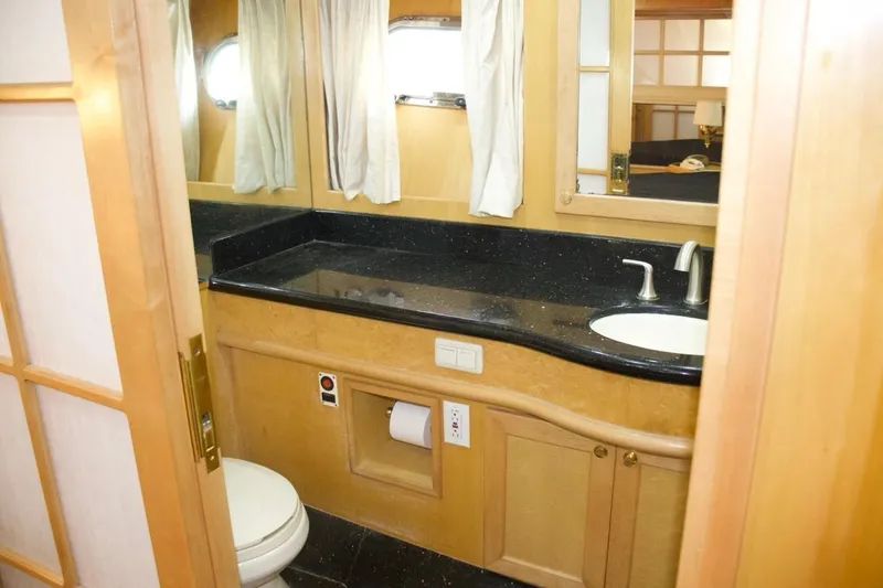  Yacht Photos Pics Luxurious bathroom in 2002 McKinna 57 Pilothouse yacht with sleek black countertop.