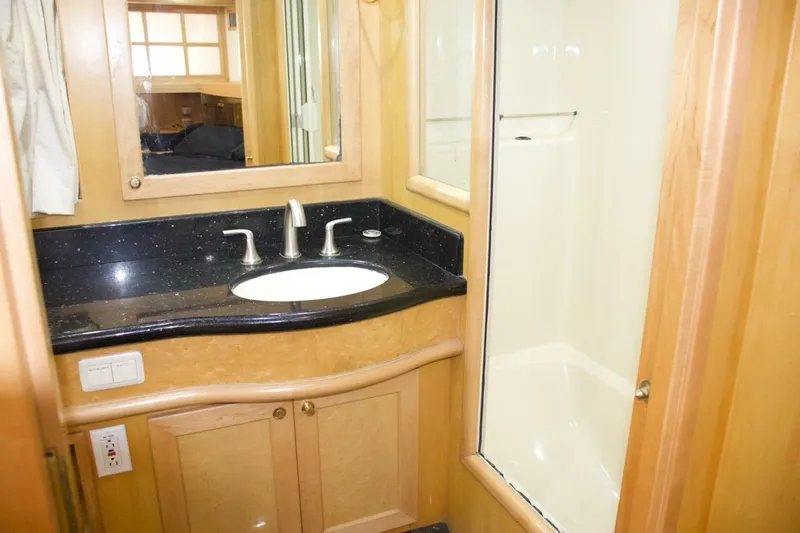  Yacht Photos Pics Luxurious bathroom in 2002 McKinna 57 Pilothouse yacht with modern fixtures and wood cabinetry.