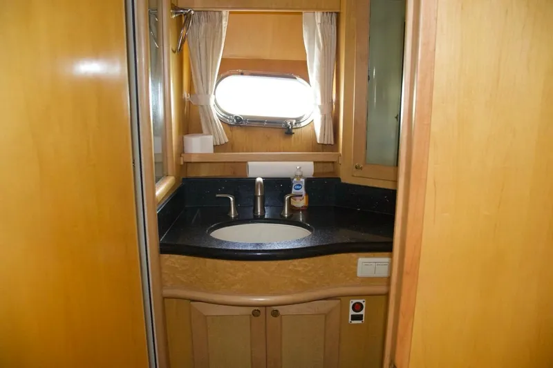 Yacht Photos Pics Luxurious bathroom in 2002 McKinna 57 Pilothouse yacht with elegant wood finish.