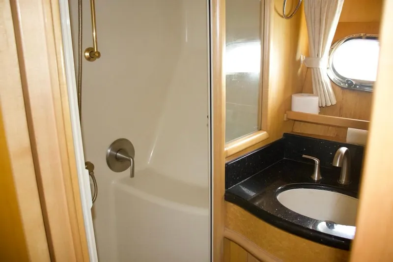  Yacht Photos Pics Bathroom interior of 2002 McKinna 57 Pilothouse yacht with shower and sink.