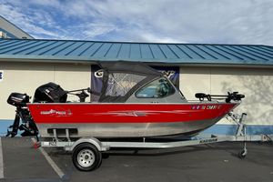 2018 Fish Rite 16.5 Stalker boat on trailer, red and silver design, parked outdoors.
