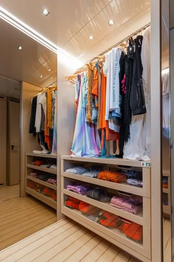Fifty Shades Yacht Photos Pics Luxurious walk-in closet on 2018 Sanlorenzo SL106 yacht, featuring elegant clothing and organized storage.
