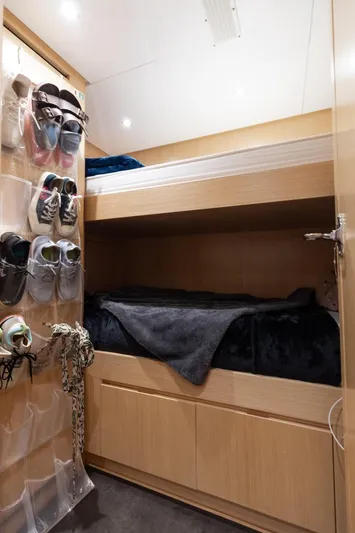 Fifty Shades Yacht Photos Pics Sanlorenzo SL106 2018 yacht cabin with bunk beds and shoe storage.