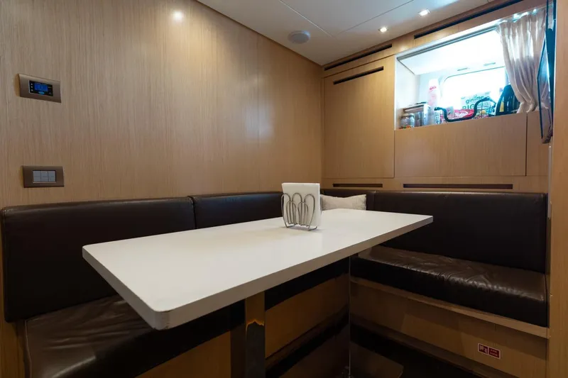 Fifty Shades Yacht Photos Pics Dining area in 2018 Sanlorenzo SL106 yacht with modern seating and table.