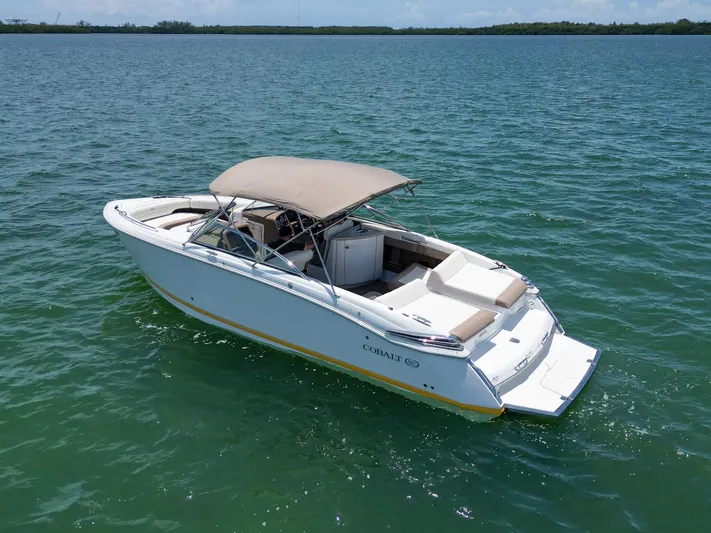  Yacht Photos Pics 2013 Cobalt 296 boat with canopy on calm water.