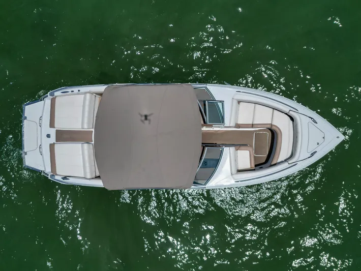  Yacht Photos Pics Overhead view of 2013 Cobalt 296 boat on green water.