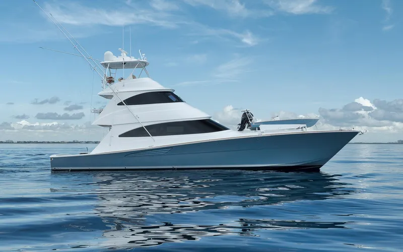 Makara Yacht Photos Pics 2018 Viking 72 Sky Bridge yacht on calm ocean under blue sky.