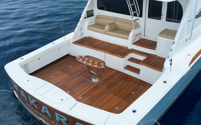 Makara Yacht Photos Pics Luxurious 2018 Viking 72 Sky Bridge yacht with teak deck and elegant seating area.