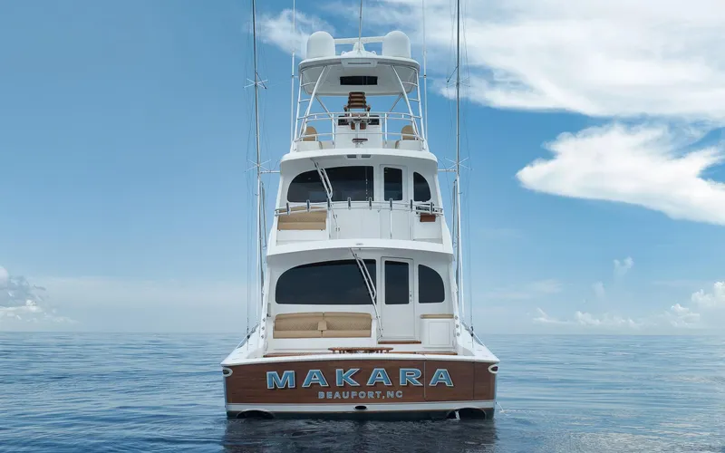 Makara Yacht Photos Pics 2018 Viking 72 Sky Bridge yacht on calm ocean, clear sky background.