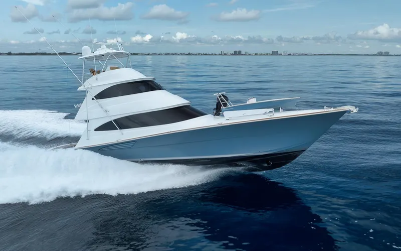 Makara Yacht Photos Pics 2018 Viking 72 Sky Bridge yacht cruising on calm ocean waters.