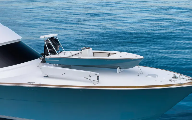 Makara Yacht Photos Pics 2018 Viking 72 Sky Bridge yacht with tender on deck, floating on calm blue water.