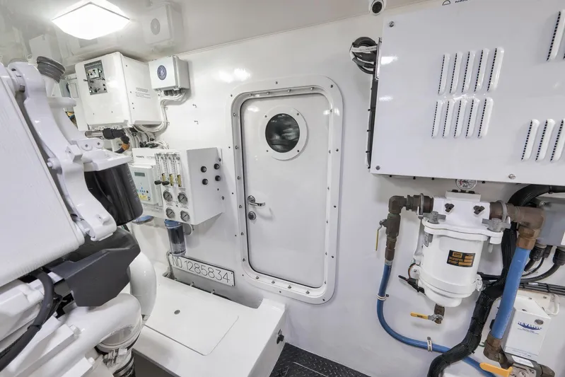 Makara Yacht Photos Pics Engine room of 2018 Viking 72 Sky Bridge yacht, featuring control panels and machinery.