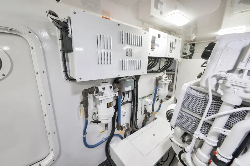 Makara Yacht Photos Pics Engine room of 2018 Viking 72 Sky Bridge yacht, showcasing mechanical systems and components.